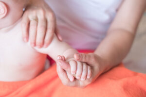 mother massaging a baby arm after brachial plexus birth injury