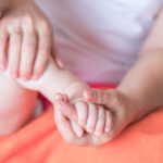 mother massaging a baby arm after brachial plexus birth injury