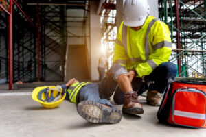 first aid being administered to a coworker at a construction site after an accident