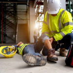 first aid being administered to a coworker at a construction site after an accident