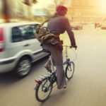 male cyclist in traffic on a city roadway