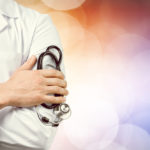 male doctor with a stethoscope with blurred background