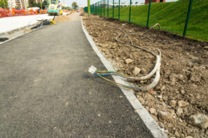 Electrical cables on sidewalk near construction site