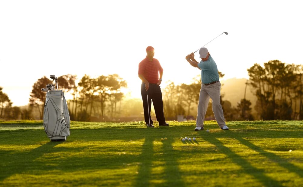 two men at golf course training