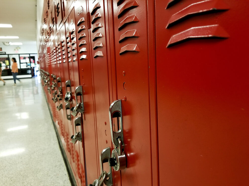 closeup view of red high school lockers in a hallway