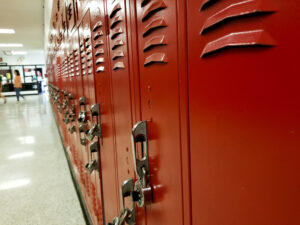 closeup view of red high school lockers in a hallway