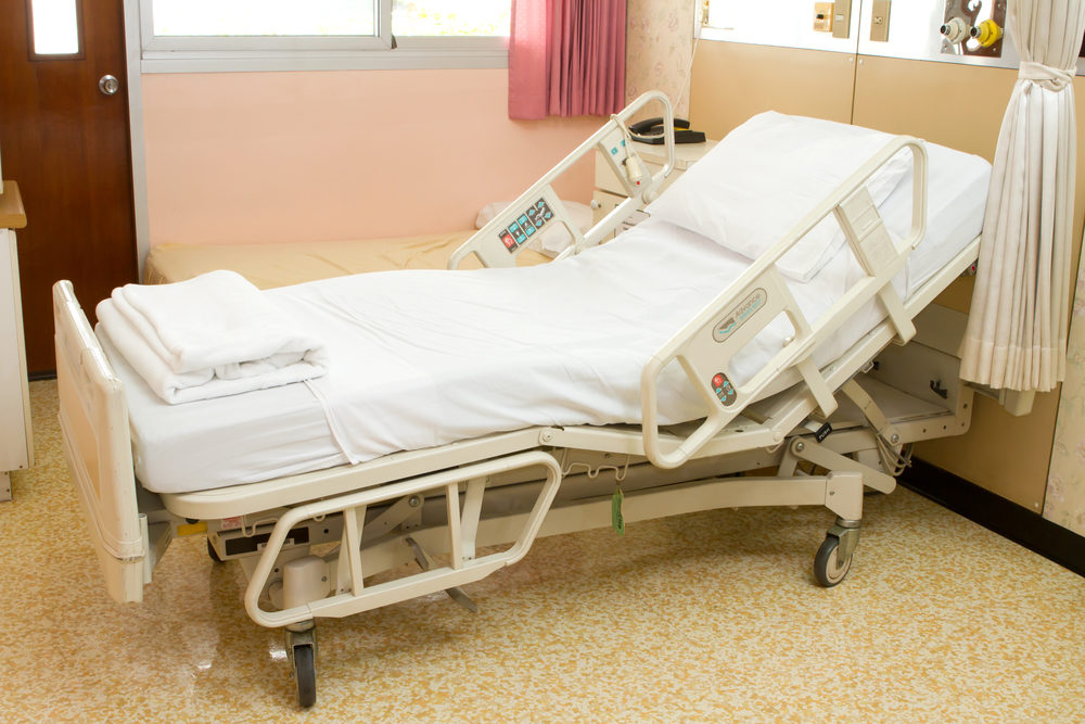 An empty hospital bed in a clean room