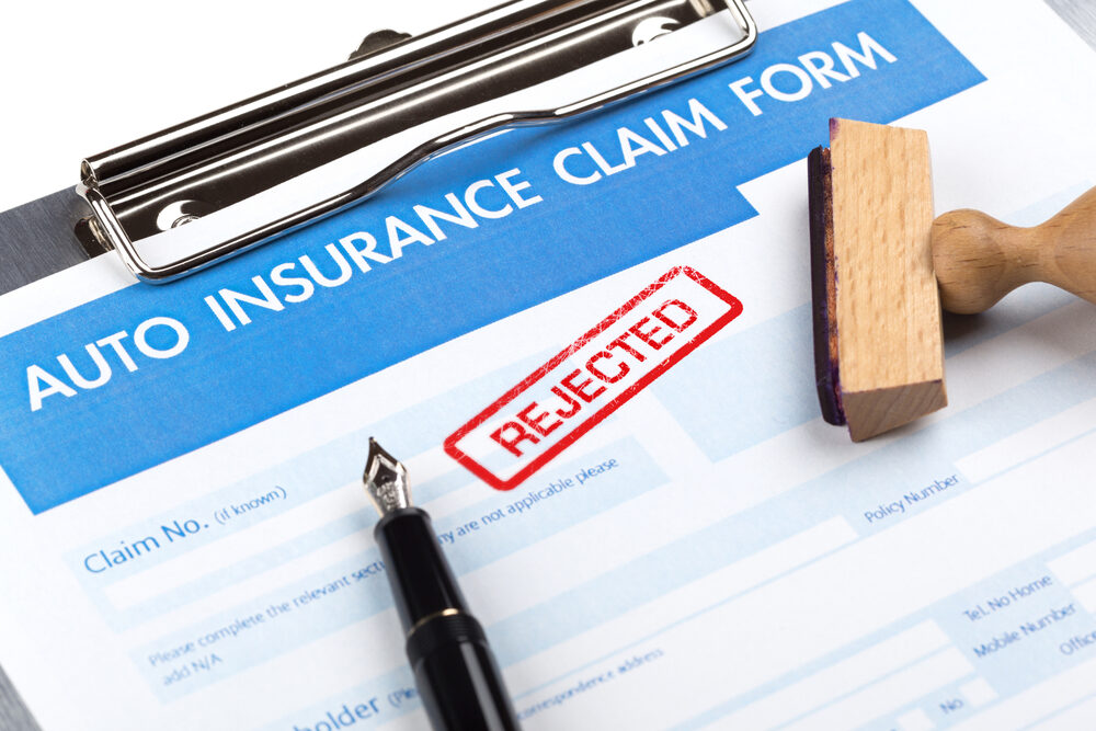 auto insurance claim form with rejected in red stamp