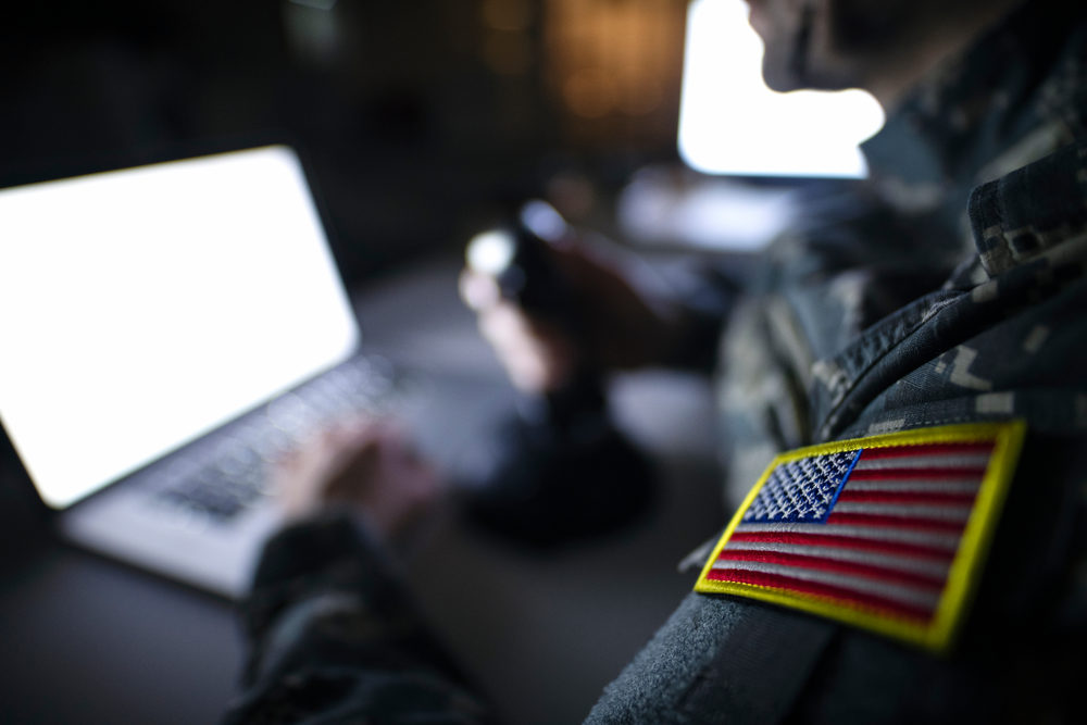 USA military intelligence working on a laptop in control center