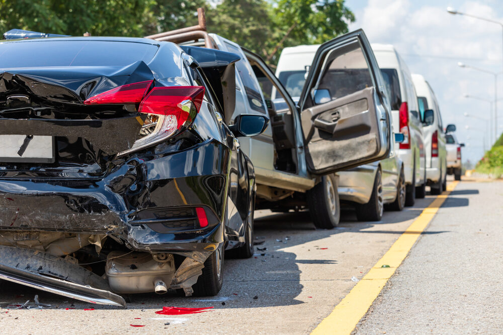 rear view of multiple cars after a crash on the road