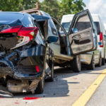 rear view of multiple cars after a crash on the road