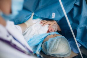 a mother with newborn after cesarean section delivery