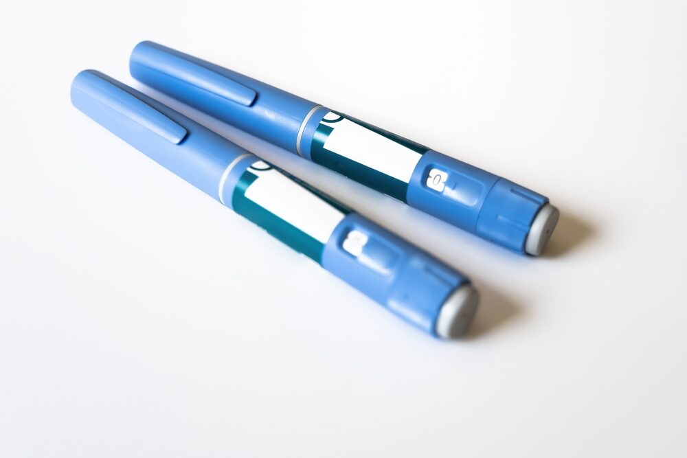 closeup of ozempic injector pens on a white table