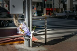 flowers left at the scene of a pedestrian accident memorial 