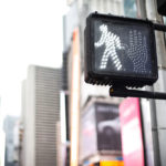 pedestrian crossing sign at traffic light in Manhattan