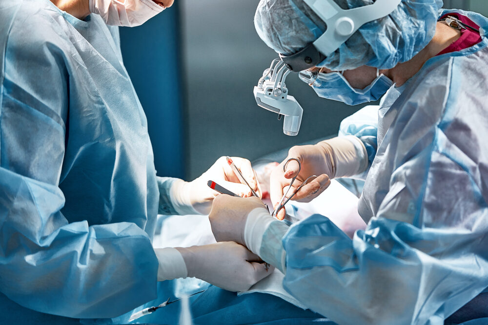 plastic surgeons in operating room performing a rhinoplasty