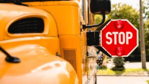 yellow school bus with stop sign out