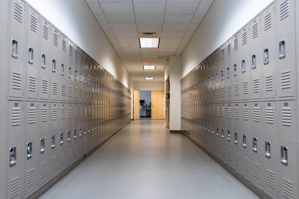 hallway in school with grey lockers along the walls