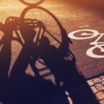 Shadow of unrecognizable cyclist riding a bike on bicycle lane 