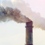 Thick smoke spews from a power plant chimney