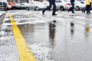 Close-up of an icy surface in a busy parking lot