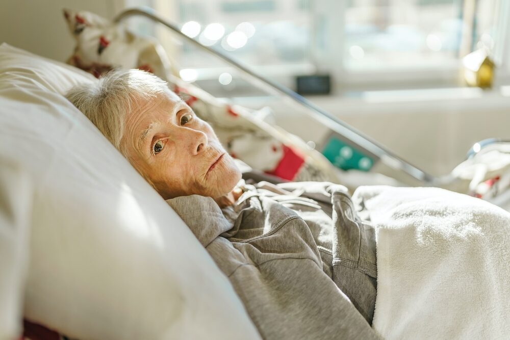sick elderly woman in a hospital bed