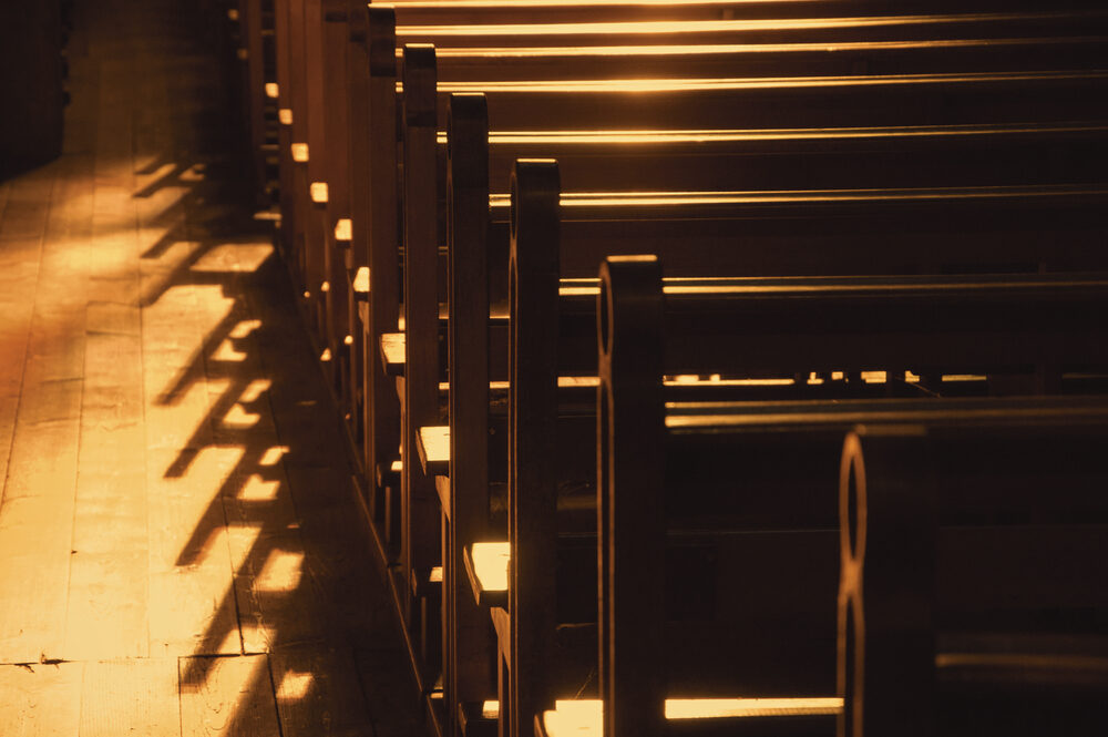 sunlight on empty catholic church pews