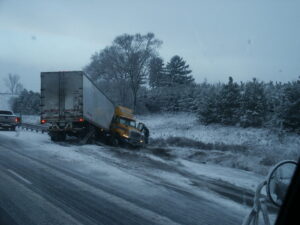 disabled truck on the side of highway after accident on a winter day