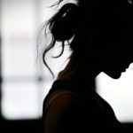 Silhouette of a young woman with her hair tied back