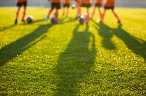 blurred view of young soccer players on a field