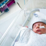 premature baby being fed formula through a tube in the hospital