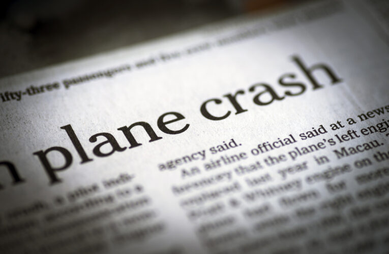 closeup of plane crash headline in newspaper