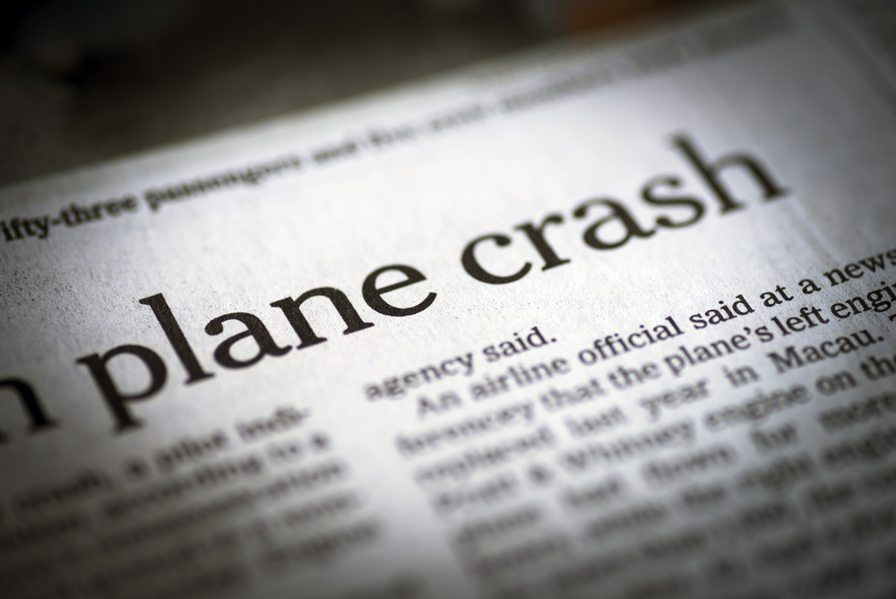 closeup of plane crash headline in newspaper